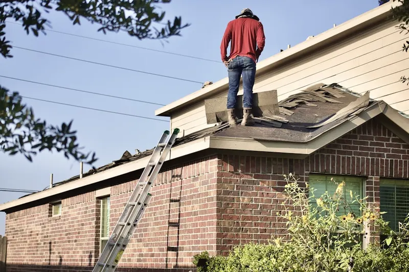Professional roofer working on a residential roof in El Salvador Community Corridor